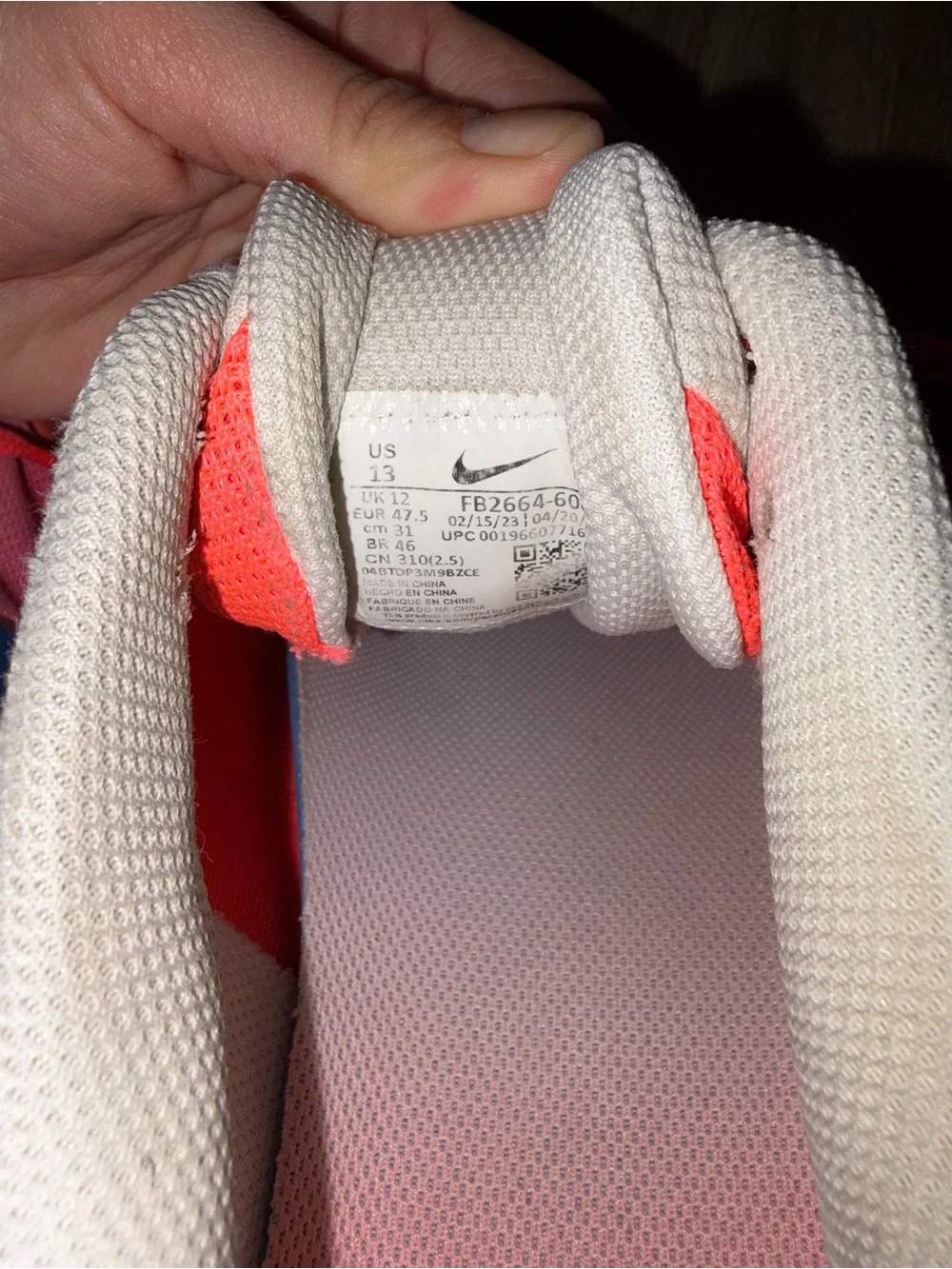 Nike Men's ' Pink/Coral Athletic Shoes with Blue Swoosh